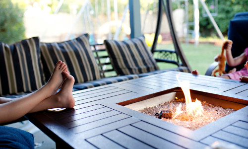 Feet resting on an outdoor fireplace