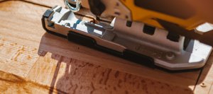 A jigsaw cutting lumber